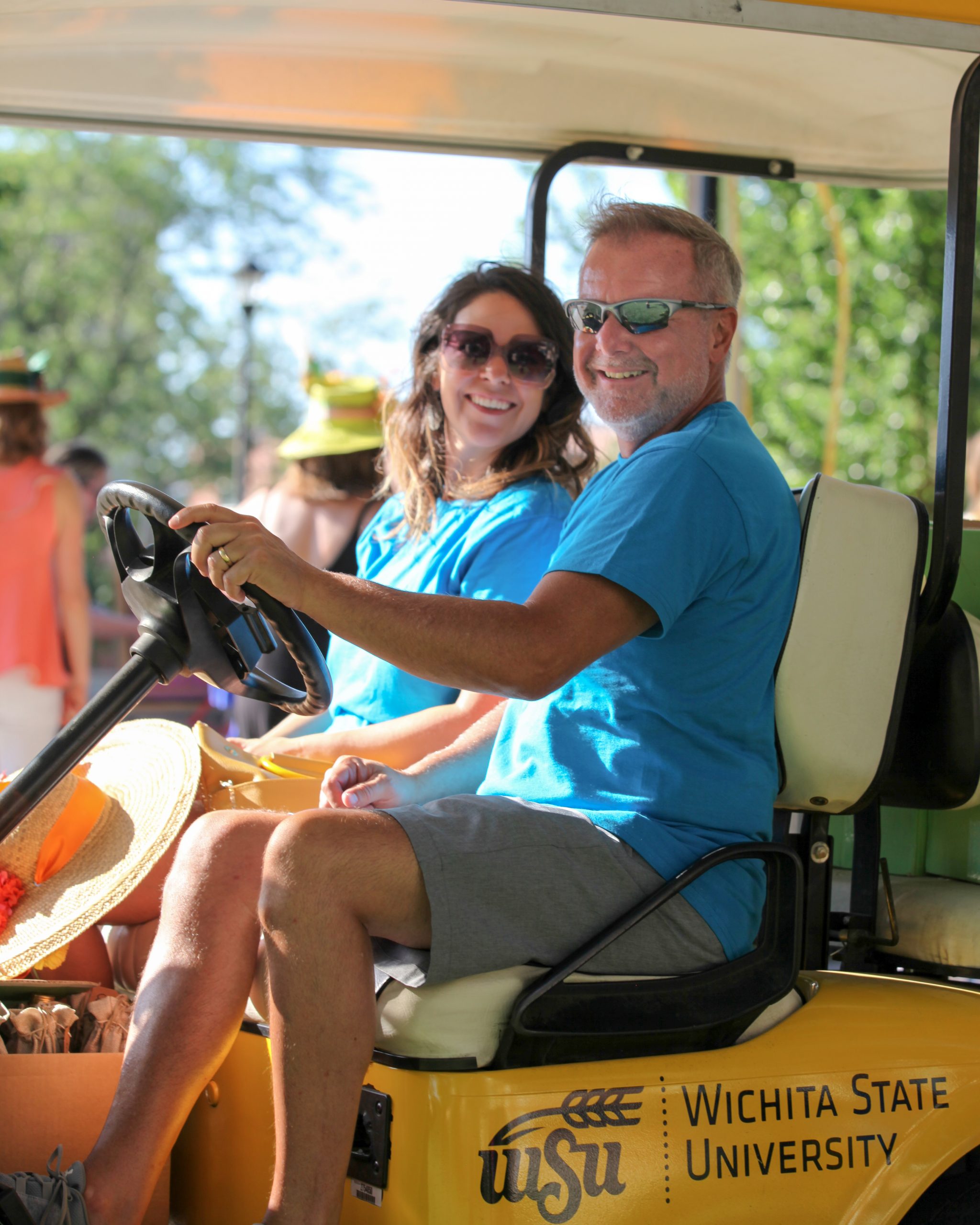 Two people in a golf cart