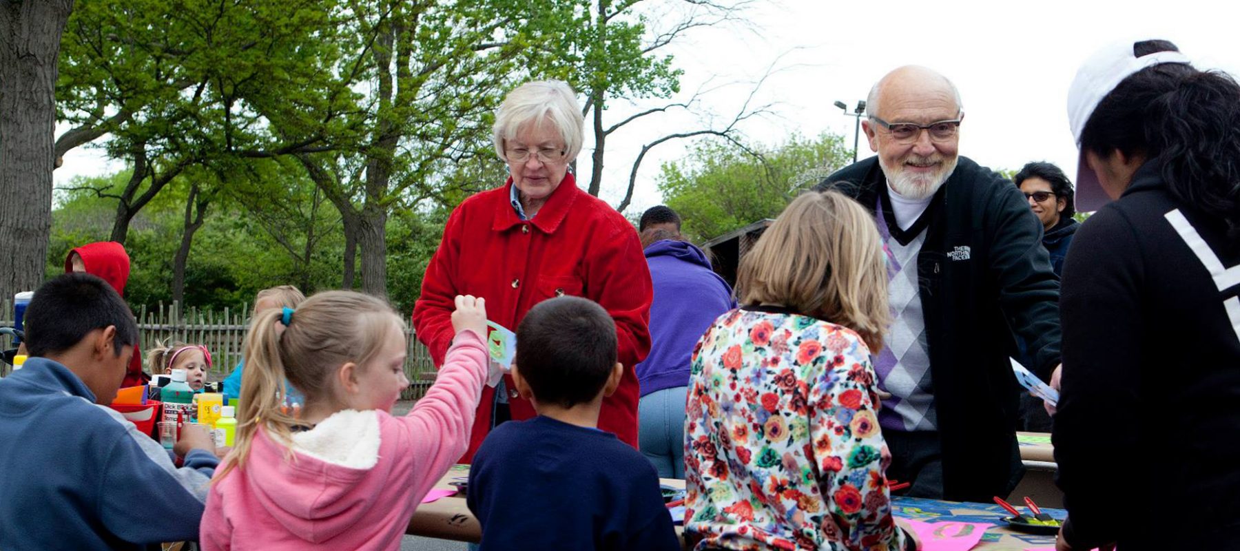 A group of people standing next to a child