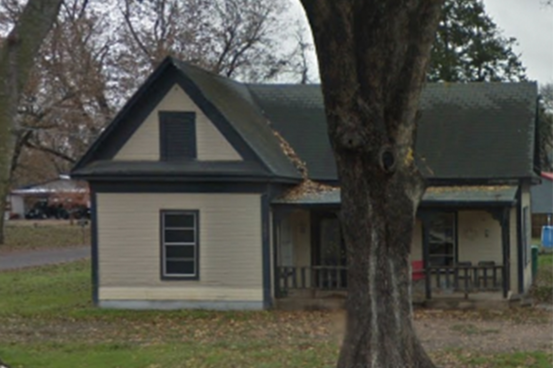 A tree in front of a house