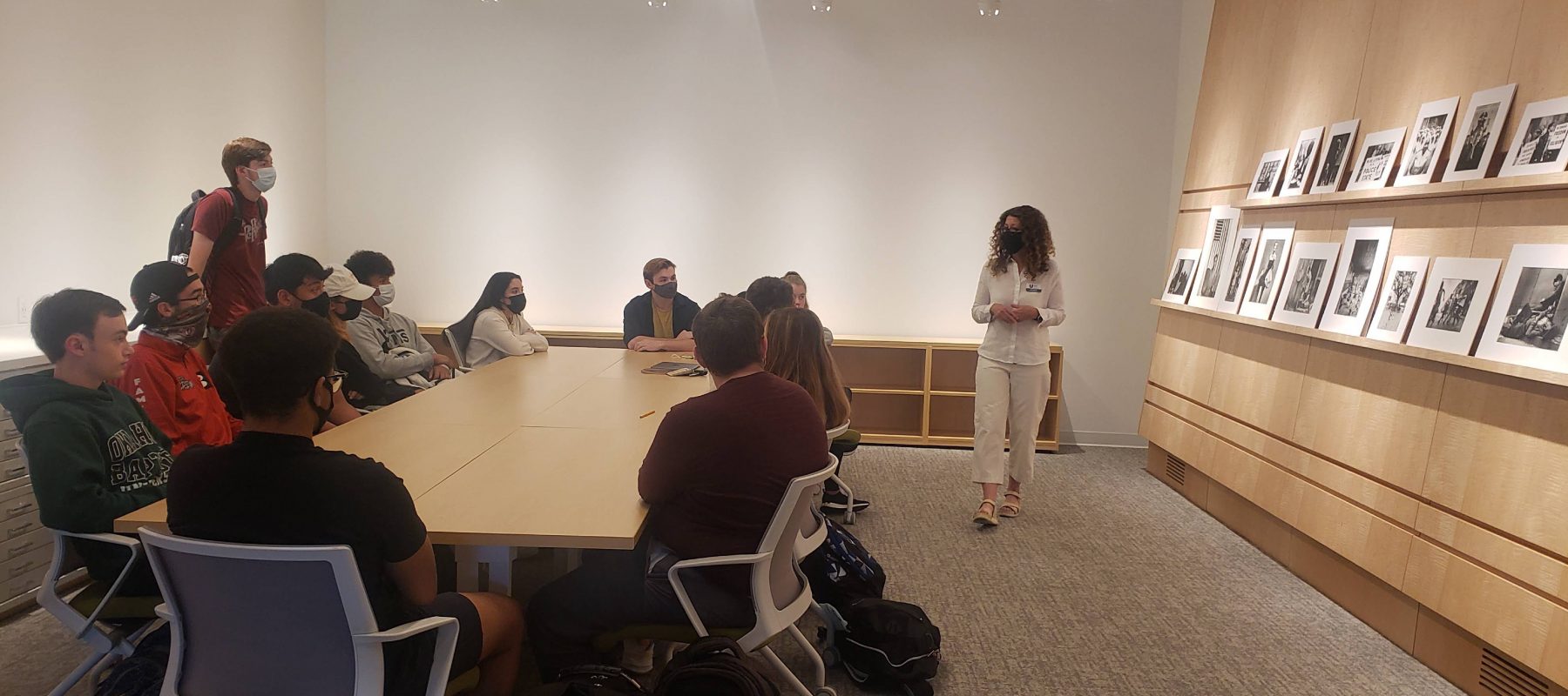 A group of people sitting at a table using a laptop