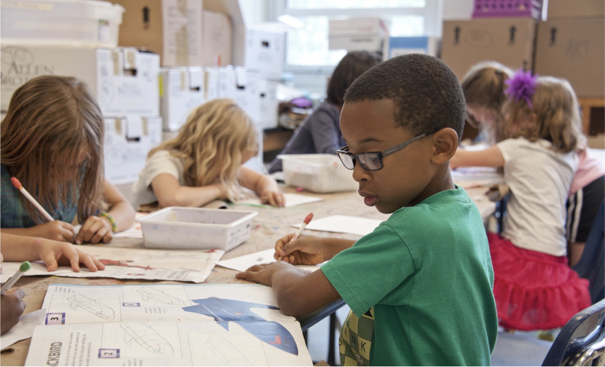 Young boy works on his school assignments.