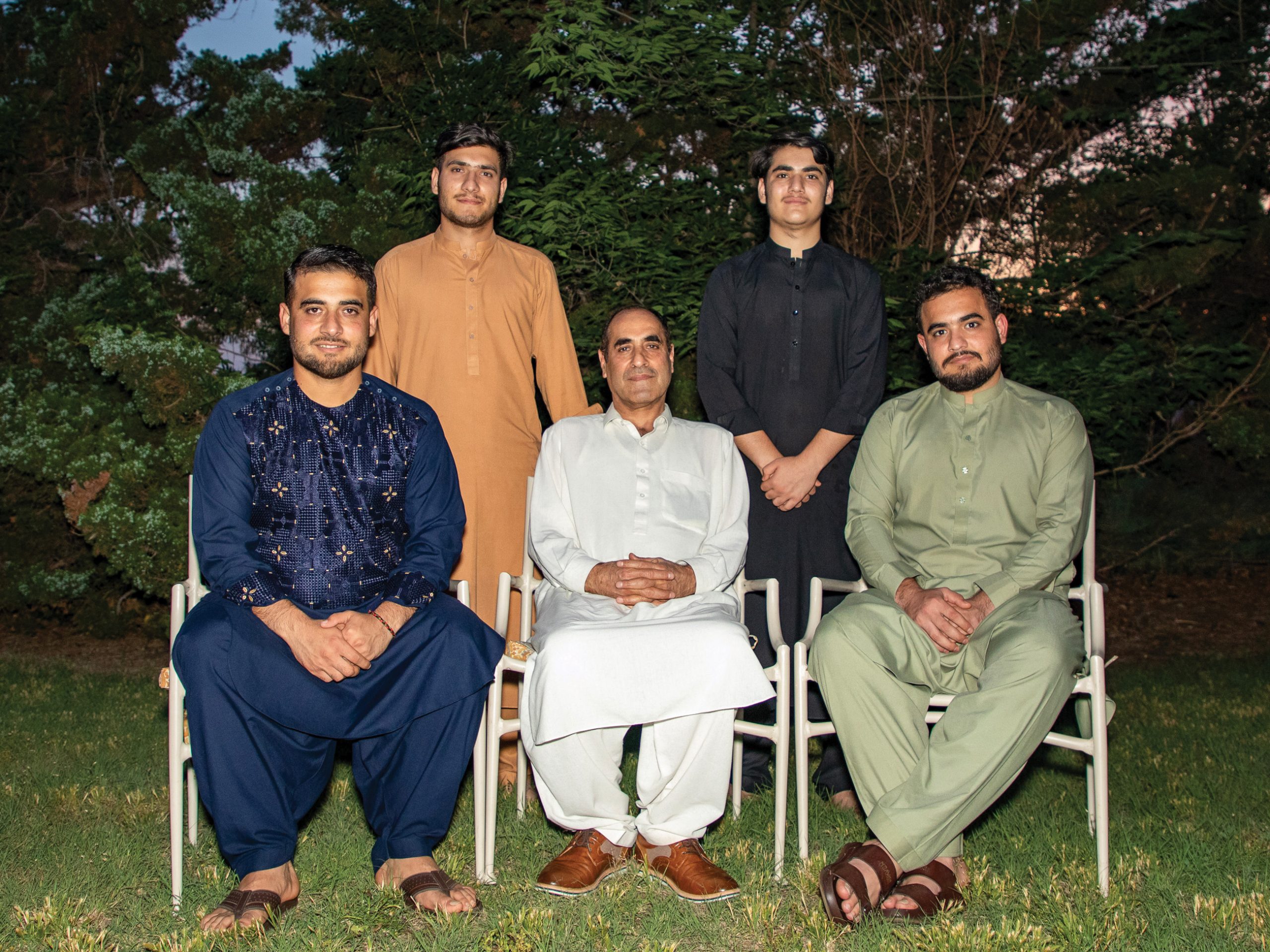 five men in traditional Afghani clothes